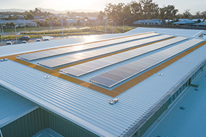 Sun shining on the solar panels of a large school building