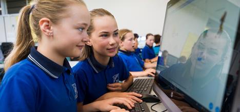 Two students looking at a computer screen.