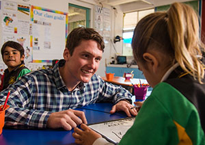 Teacher and student on table in the classroom